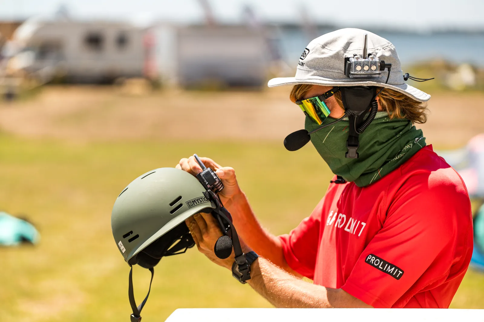 Wojciech Stopa preparing a helmet and radio before a kitesurfing lesson in Sicily